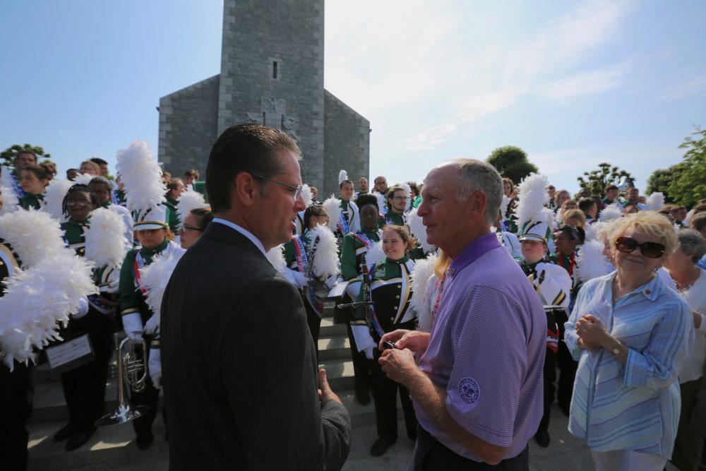 UNC Charlotte Director of Bands Shawn Smith chats with Chancellor Phil Dubois shortly after the Pride of Niner Nation Marching Band’s performance at the Brittany American Cemetery in Normandy, France.